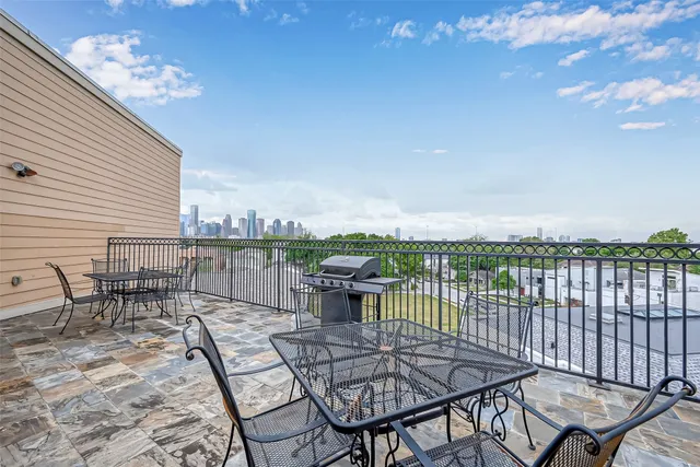 a view of a balcony with table and chairs