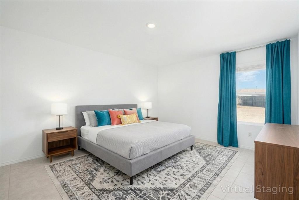 7524 Larson Lane McKinney, TX 75071 - Photo 14 of 24 a bedroom with a bed and a large window