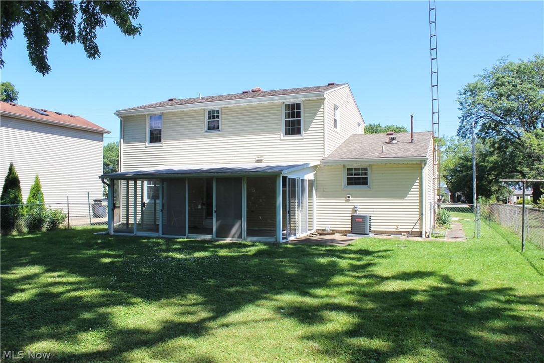 11910 West Lake Road Vermilion, OH 44089 - Photo 4 of 28 Back of property featuring central AC unit and a yard
