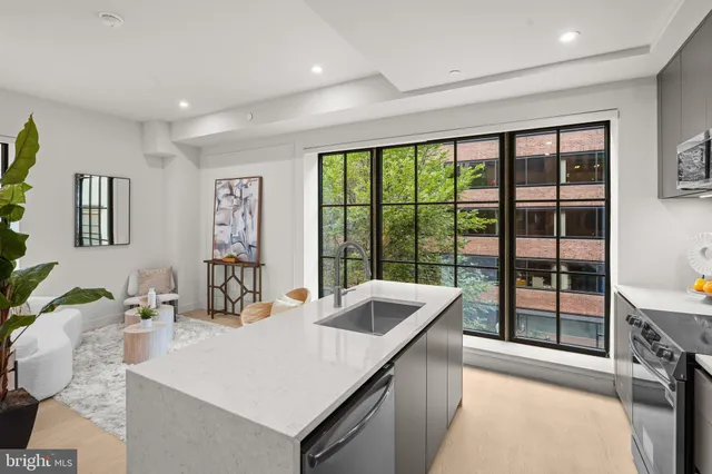 a kitchen with a sink and large window