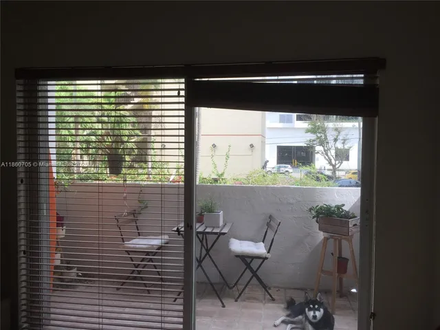 a view of a balcony with chair and table