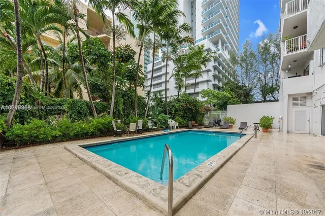 a view of swimming pool with outdoor seating and plants