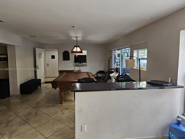 a living room with furniture a chandelier and a window