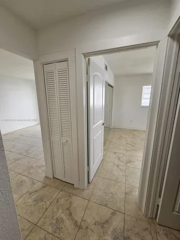 a view of a fan & a window in a room