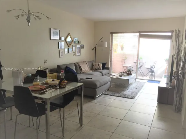a living room with couches a coffee table and a piano table with wooden floor