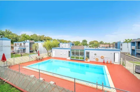 a view of a swimming pool with an outdoor seating