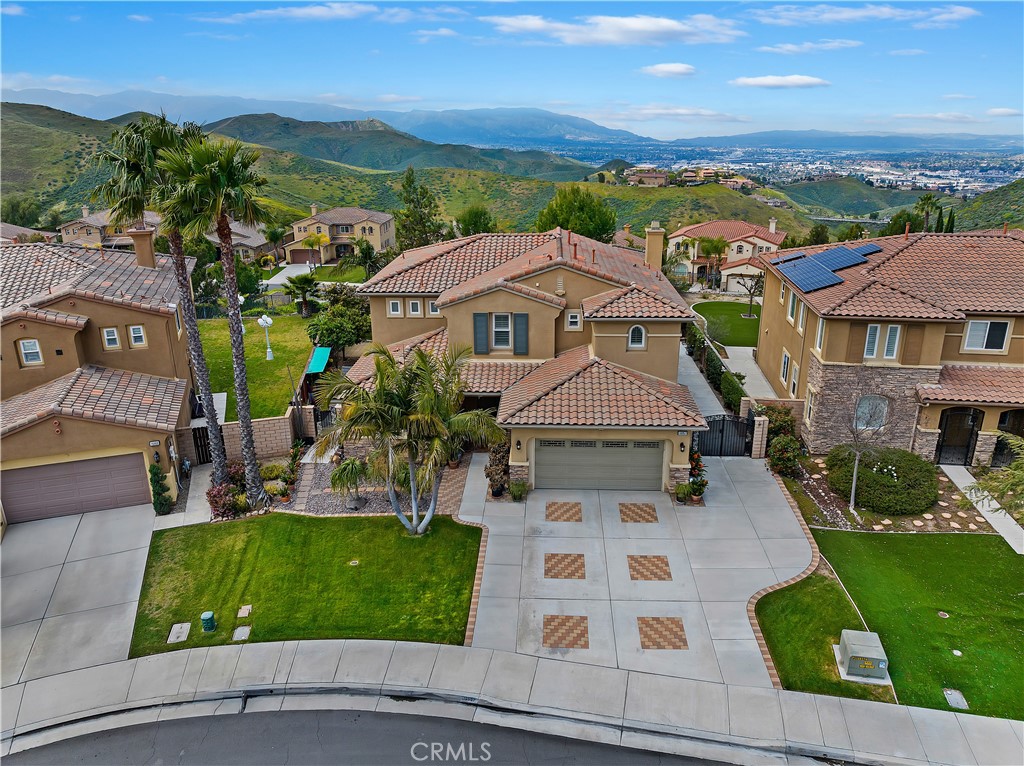an aerial view of a house with garden space and street view