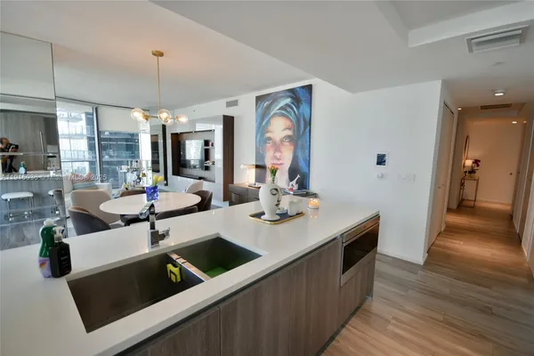 a view of a kitchen counter space a sink and living room view