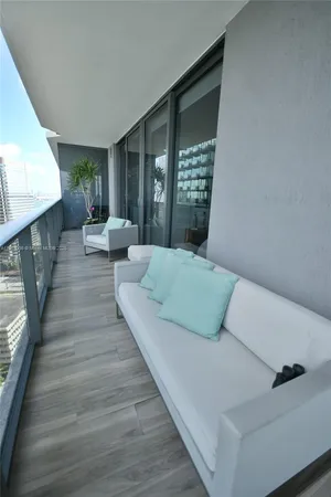 a large bed sitting in a bedroom next to a window
