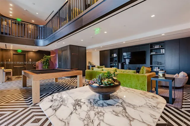 a kitchen with stainless steel appliances kitchen island granite countertop a table and chairs