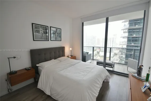 a bedroom with a large bed and a large window