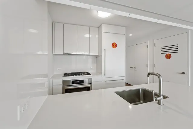 a kitchen with a sink and a stove top oven