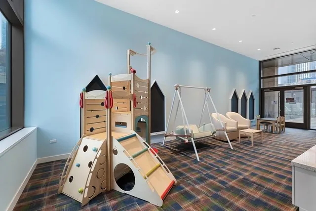 a living room with fireplace furniture and a ceiling fan
