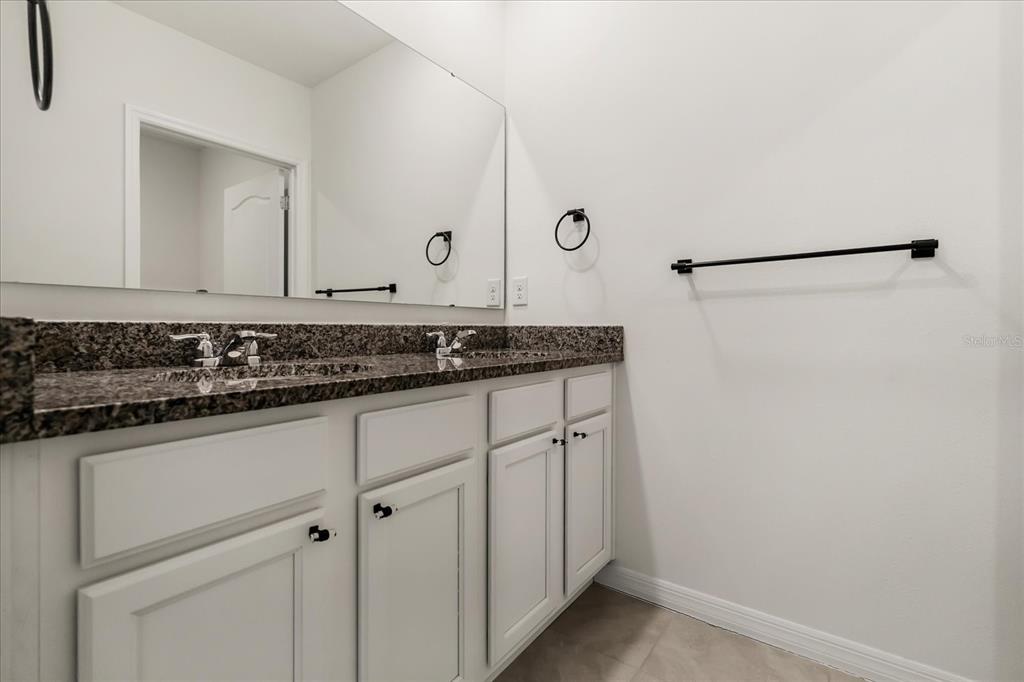 6814 Grace Hammock Road Harmony, FL 34773 - Photo 11 of 41 a bathroom with a sink and a mirror