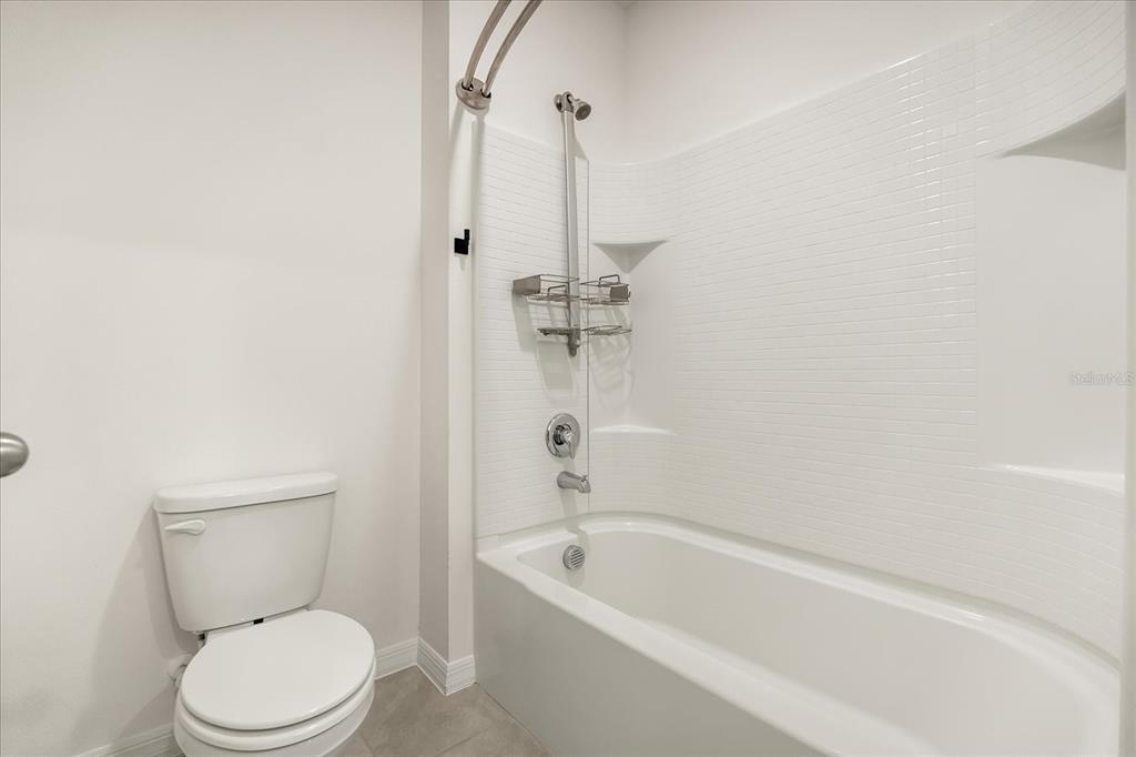 6814 Grace Hammock Road Harmony, FL 34773 - Photo 12 of 41 a bathroom with a toilet a sink and a bathtub