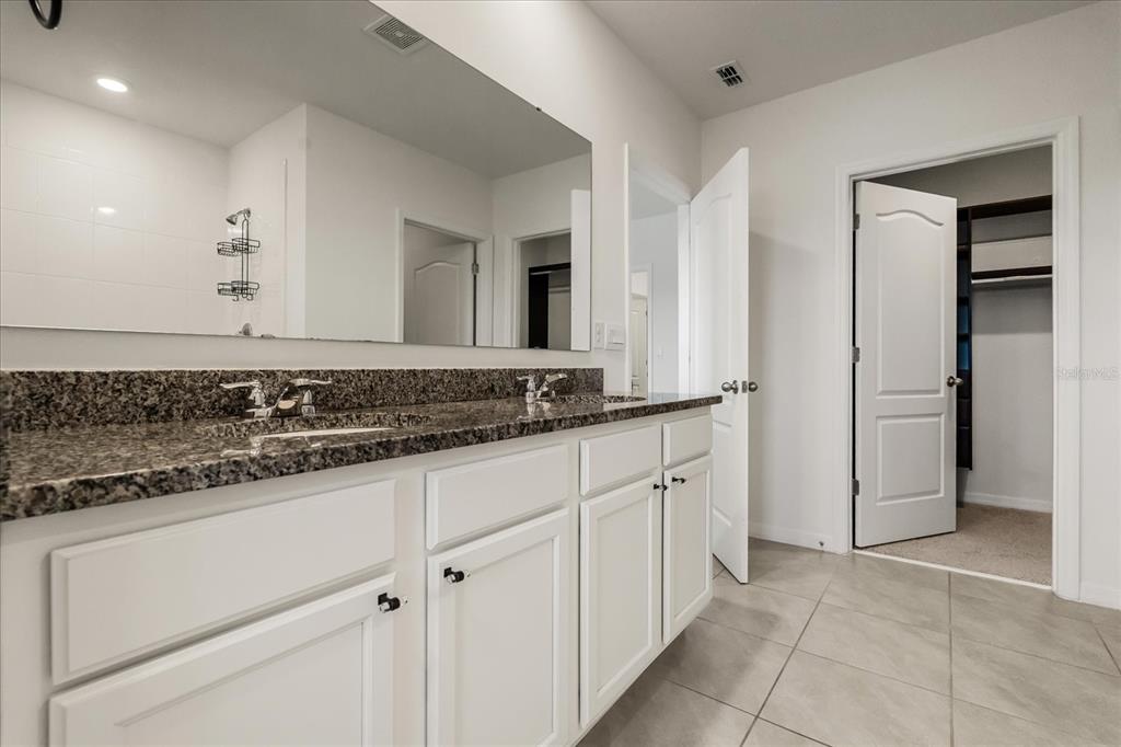 6814 Grace Hammock Road Harmony, FL 34773 - Photo 26 of 41 a bathroom with a sink and a mirror