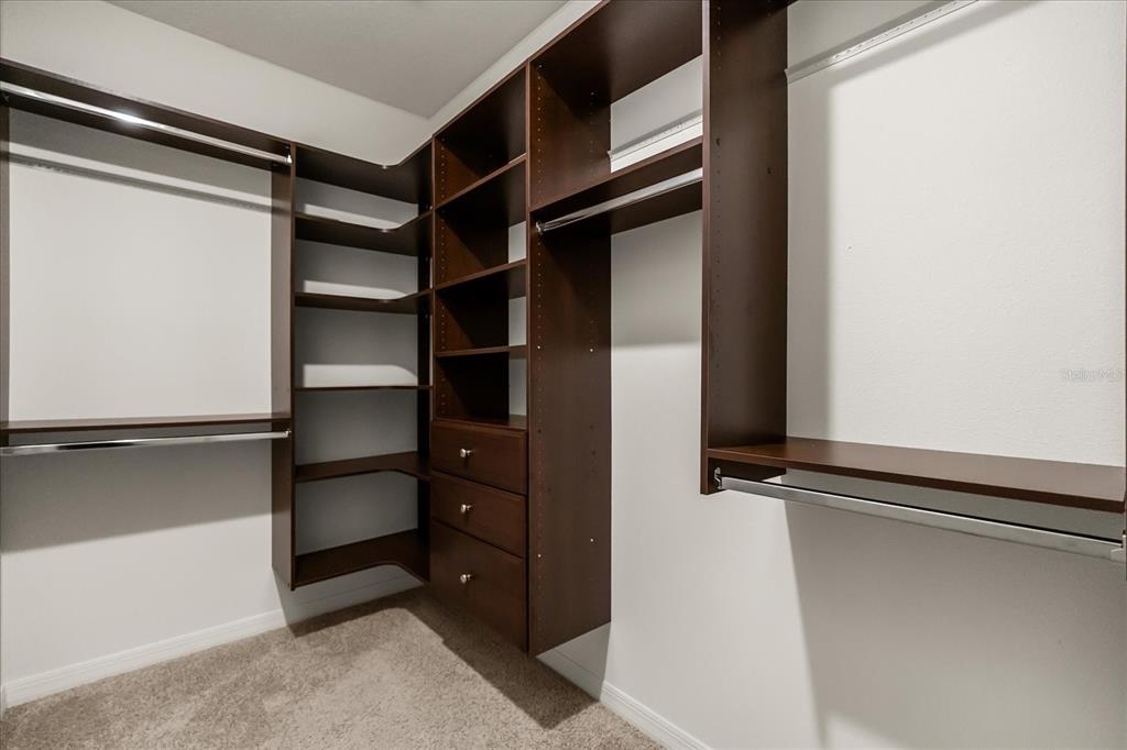 6814 Grace Hammock Road Harmony, FL 34773 - Photo 28 of 41 a view of walk in closet with empty racks