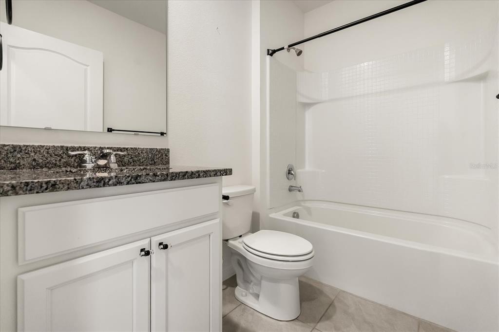 6814 Grace Hammock Road Harmony, FL 34773 - Photo 31 of 41 a bathroom with a shower a toilet and sink