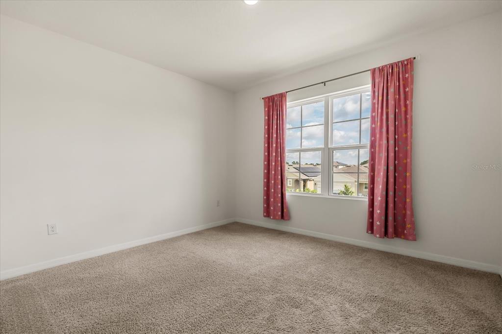 6814 Grace Hammock Road Harmony, FL 34773 - Photo 9 of 41 an empty room with windows