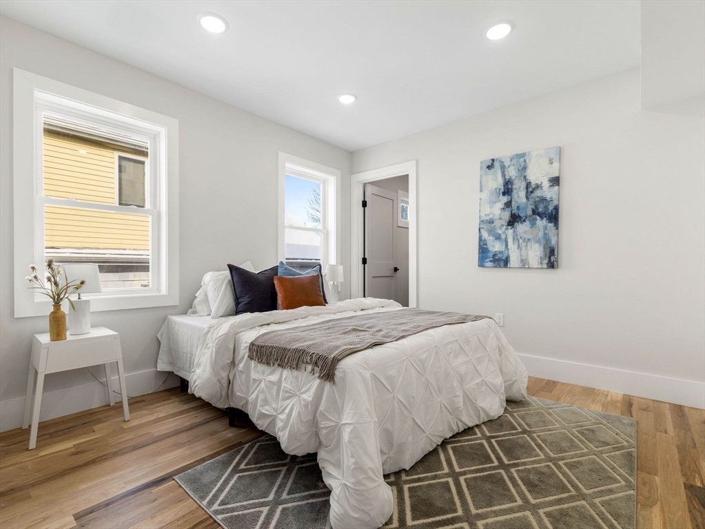 16 High Street, Unit 2 Somerville, MA 02144 - Photo 12 of 34 a spacious bedroom with a bed and a window