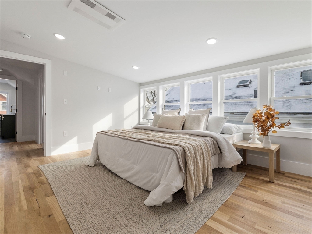 16 High Street, Unit 2 Somerville, MA 02144 - Photo 15 of 34 a spacious bedroom with a bed and wooden floor