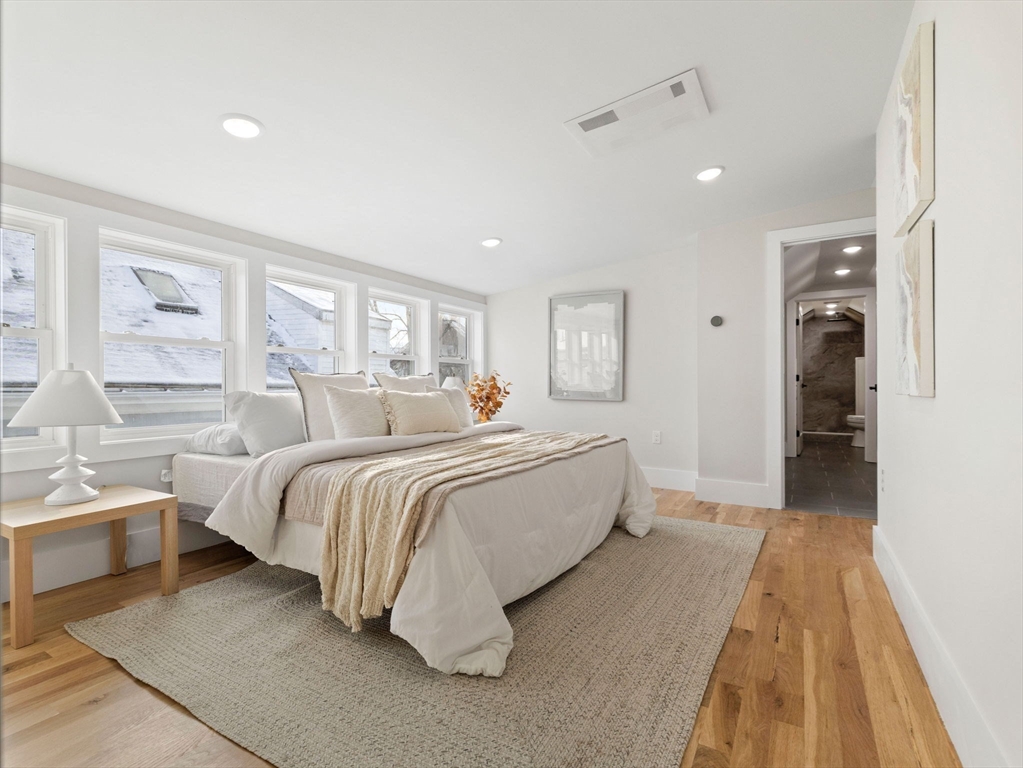 16 High Street, Unit 2 Somerville, MA 02144 - Photo 16 of 34 a spacious bedroom with a bed and a large window
