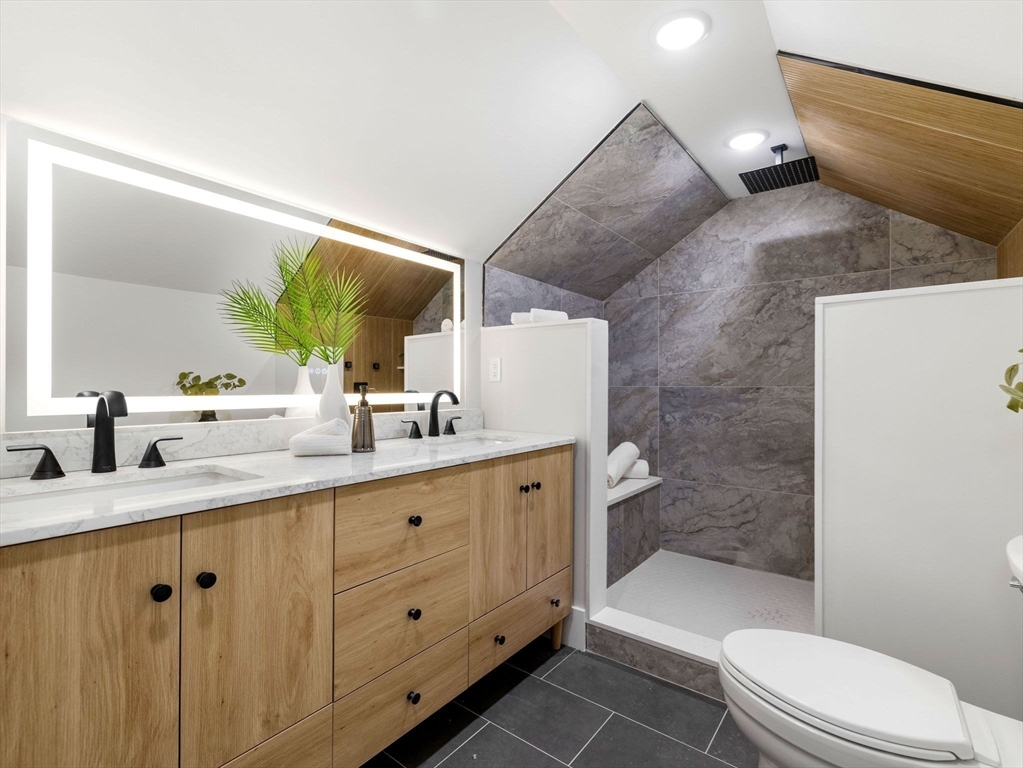 16 High Street, Unit 2 Somerville, MA 02144 - Photo 17 of 34 a bathroom with a granite countertop sink mirror vanity and toilet