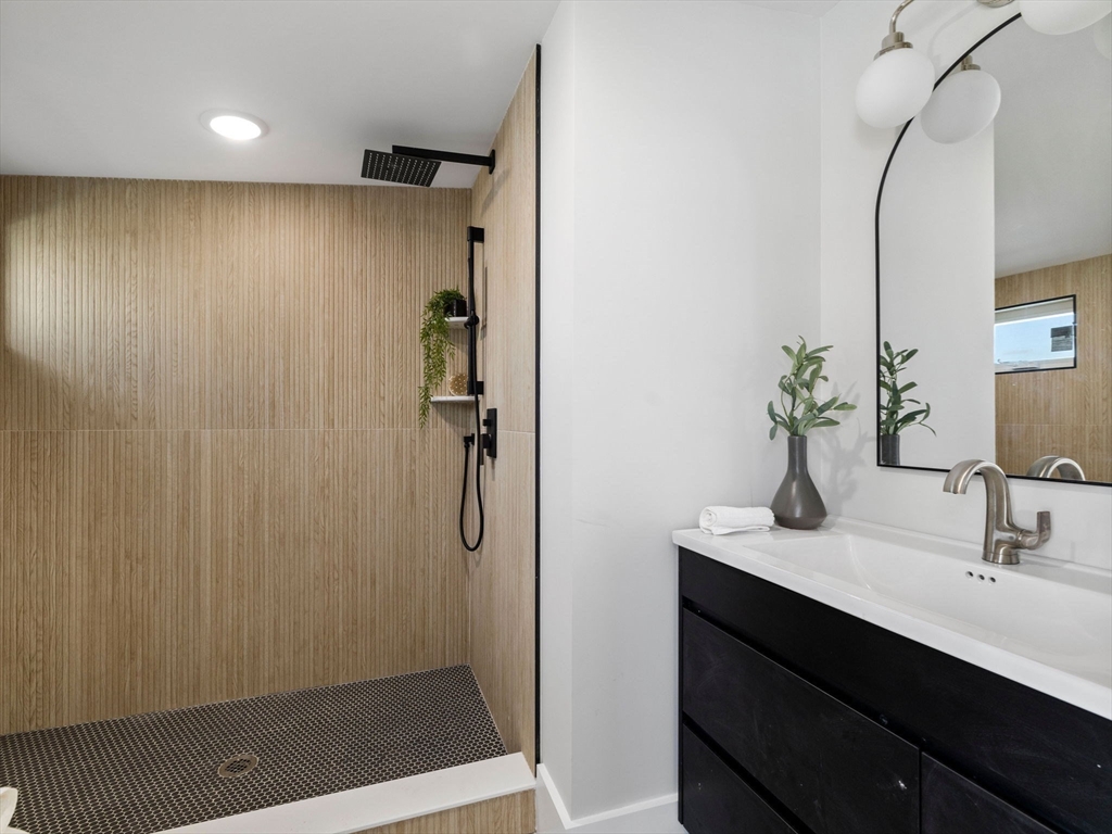 16 High Street, Unit 2 Somerville, MA 02144 - Photo 22 of 34 a bathroom with a shower sink and mirror