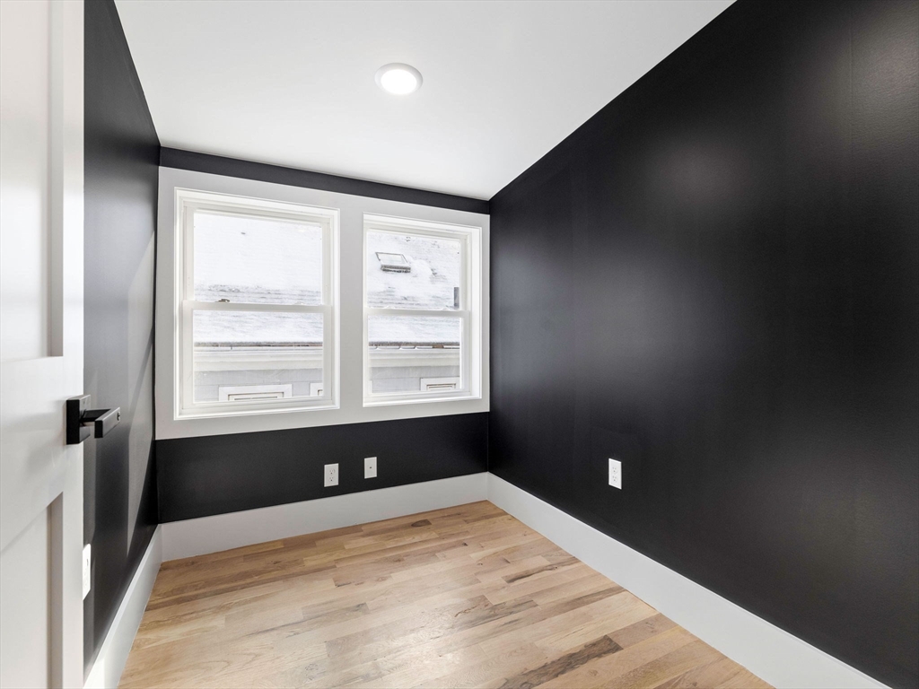 16 High Street, Unit 2 Somerville, MA 02144 - Photo 24 of 34 a bed sitting in a bedroom next to a window