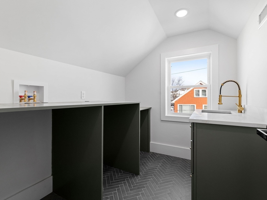 16 High Street, Unit 2 Somerville, MA 02144 - Photo 25 of 34 a kitchen with a sink a refrigerator and cabinets