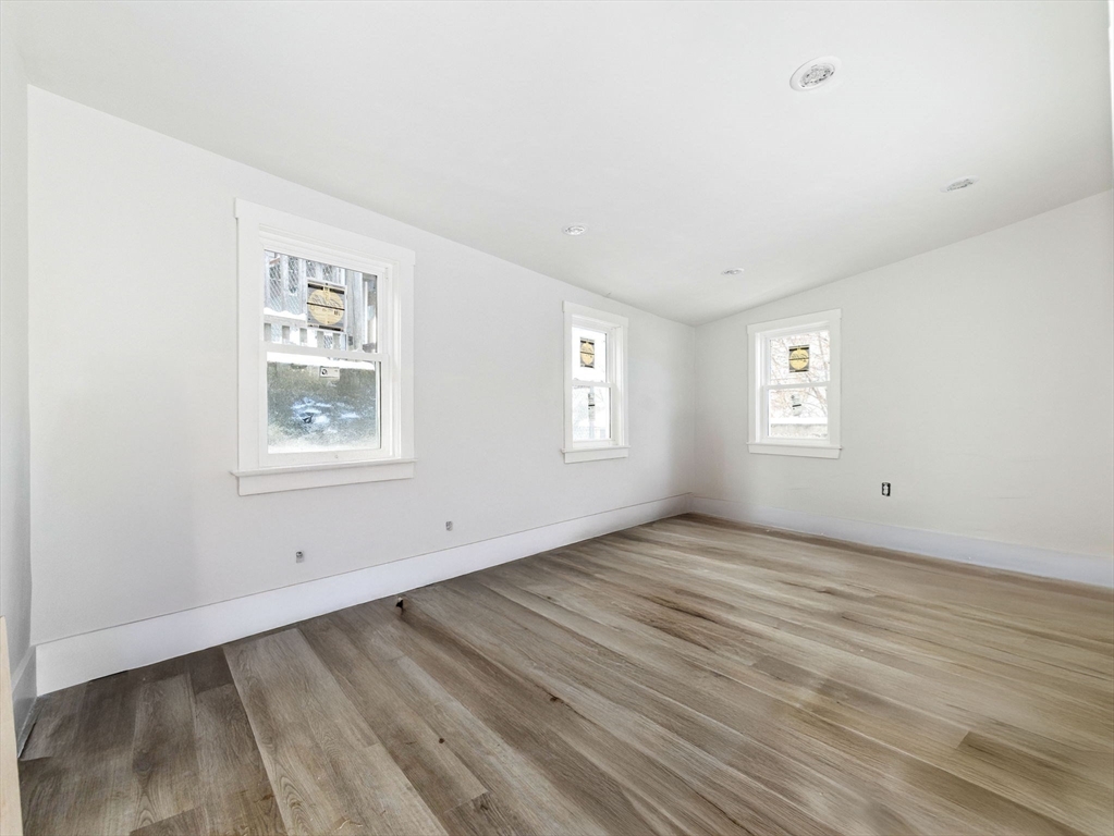 16 High Street, Unit 2 Somerville, MA 02144 - Photo 30 of 34 a view of an empty room with wooden floor and a window