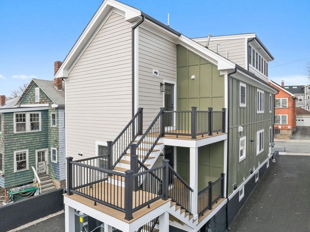 16 High Street, Unit 2 Somerville, MA 02144 - Photo 32 of 34 a view of a house with a wooden deck