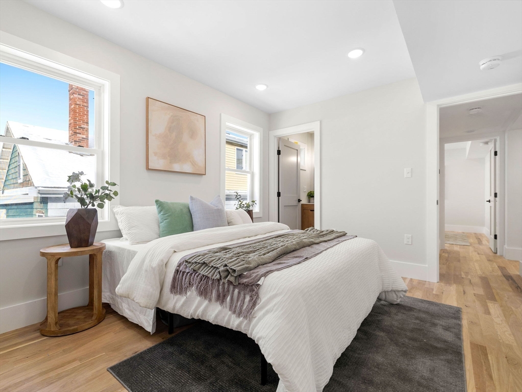 16 High Street, Unit 2 Somerville, MA 02144 - Photo 9 of 34 a bedroom with a bed and wooden floor
