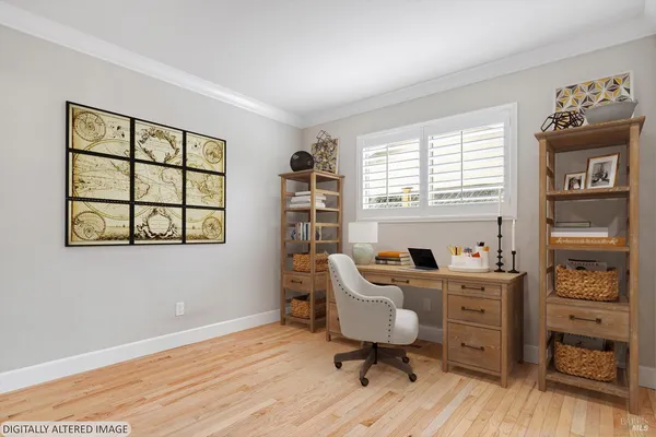 a view of a workspace with furniture and a window