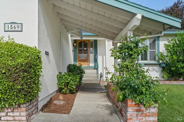 front view of a house with potted plants