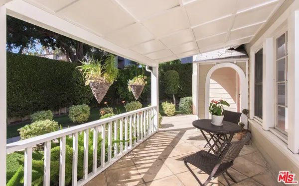 a view of a porch with furniture and garden