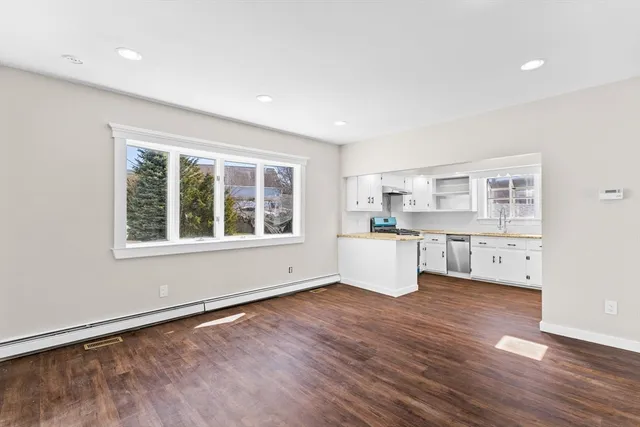 a kitchen with a wooden floor and window