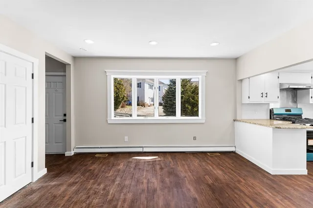 a view of a kitchen with wooden floor and a sink