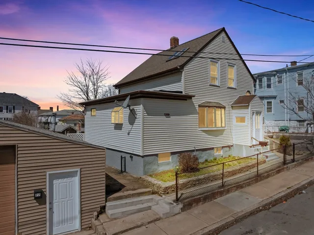 a front view of a house with a street