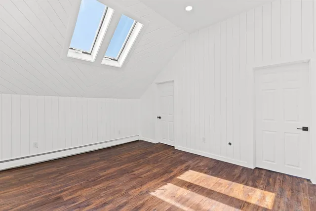 a view of a room that has wooden floor and bench
