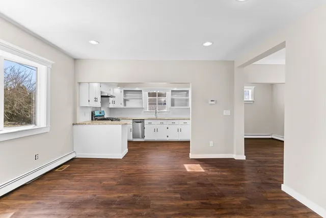 a view of kitchen with furniture and wooden floor