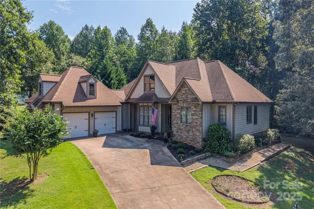 a view of house with garden space and swimming pool