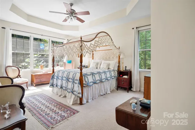 a bedroom with furniture and a chandelier