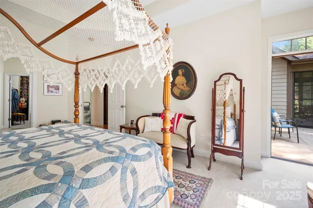 a bedroom with a bed a mirror and paintings on the wall