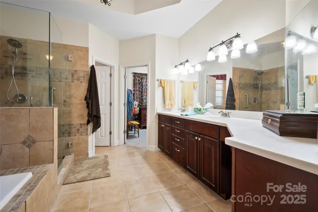 a spacious bathroom with a sink mirror and shower