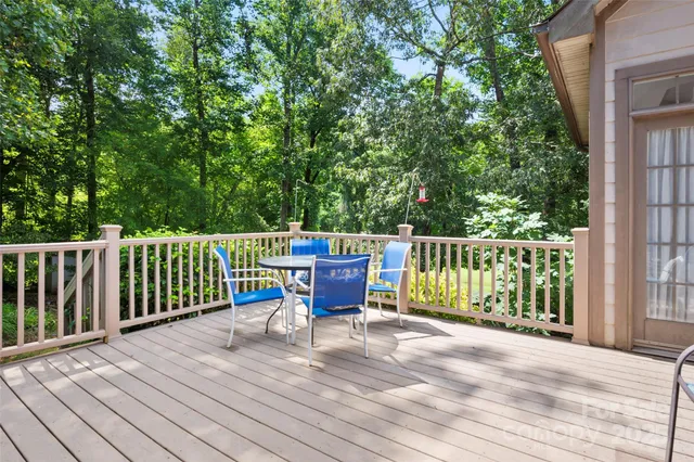 a view of a deck with two chairs and wooden floor