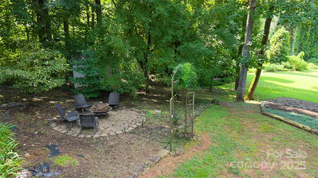 a view of a backyard with sitting area