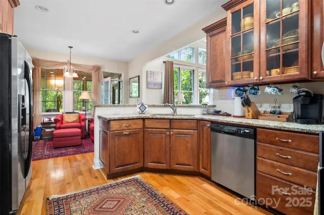 a kitchen with stainless steel appliances granite countertop a sink and cabinets