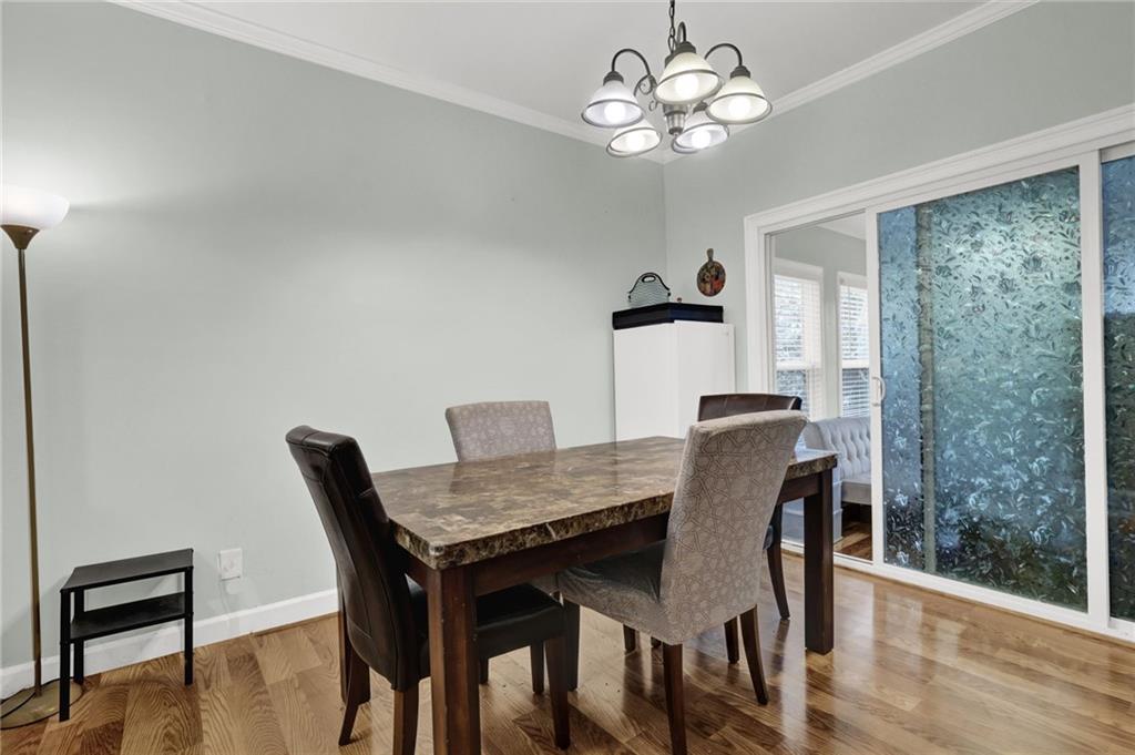 3825 Lavista Road, Unit O1 Tucker, GA 30084 - Photo 13 of 36 a view of a dining room with furniture wooden floor and chandelier