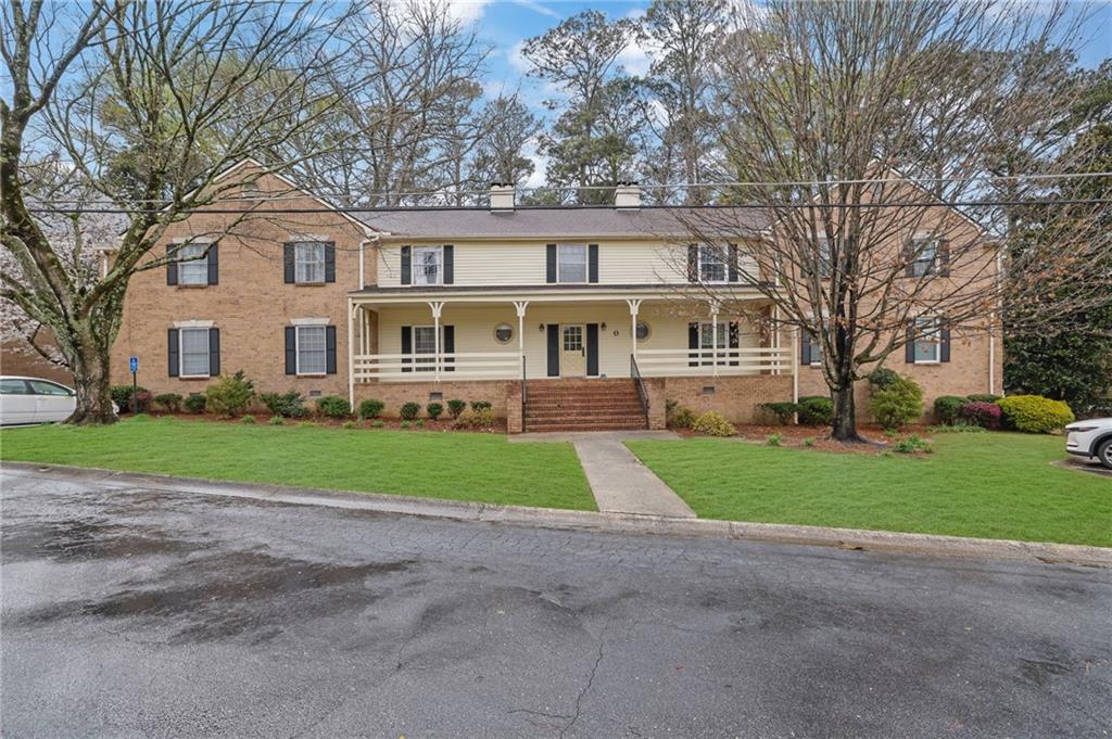 3825 Lavista Road, Unit O1 Tucker, GA 30084 - Photo 2 of 36 a front view of house with yard and green space